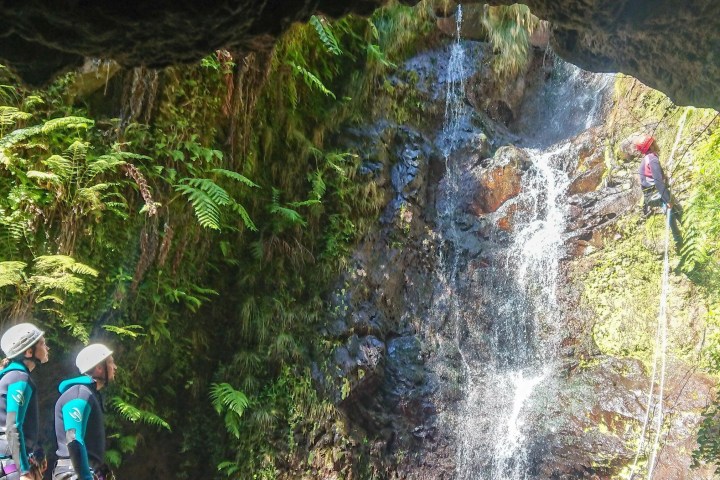 a person standing next to a waterfall