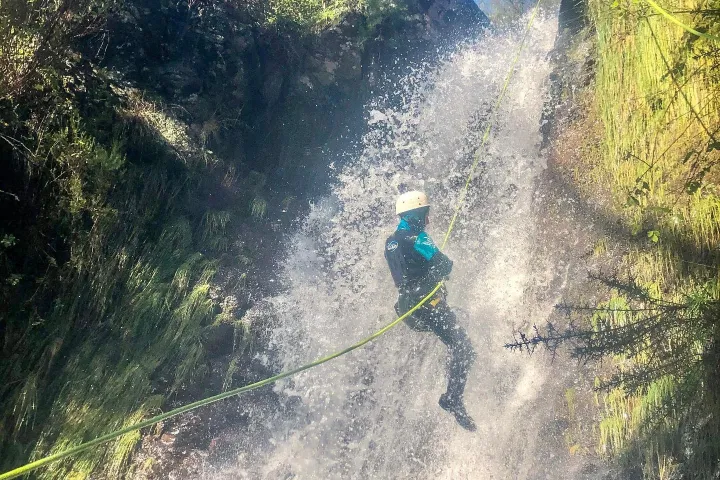 a man jumping from a cliff