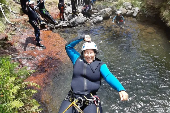 a person repelling down a cliff