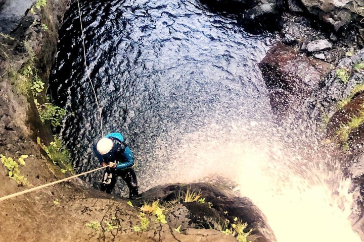 a man repelling down a cliff