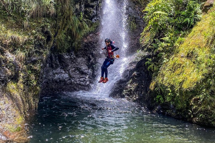 a large waterfall over some water