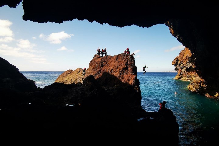 a large body of water with a mountain in the background