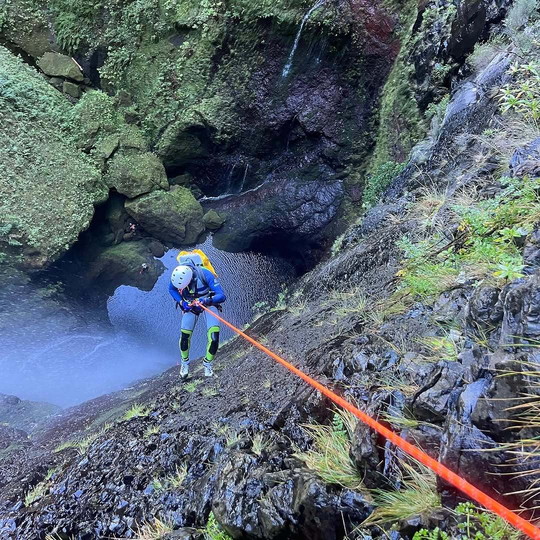 Canyoneer on a rope during a canyoning descent in Madeira