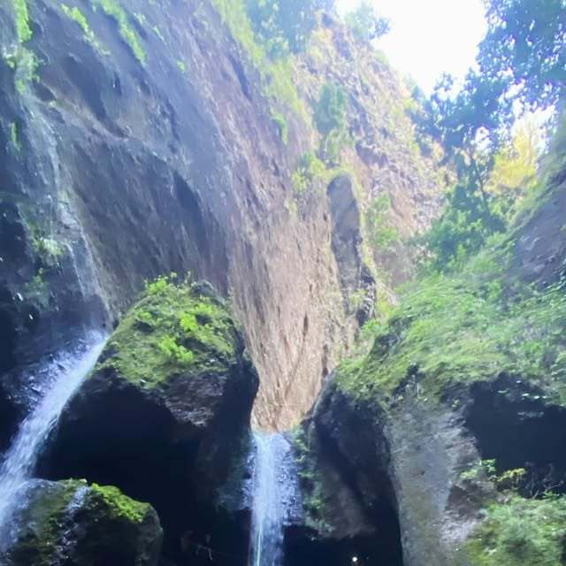 Moss-covered gorge with two waterfalls and a levada path in Ponta do Sol, Madeira Island